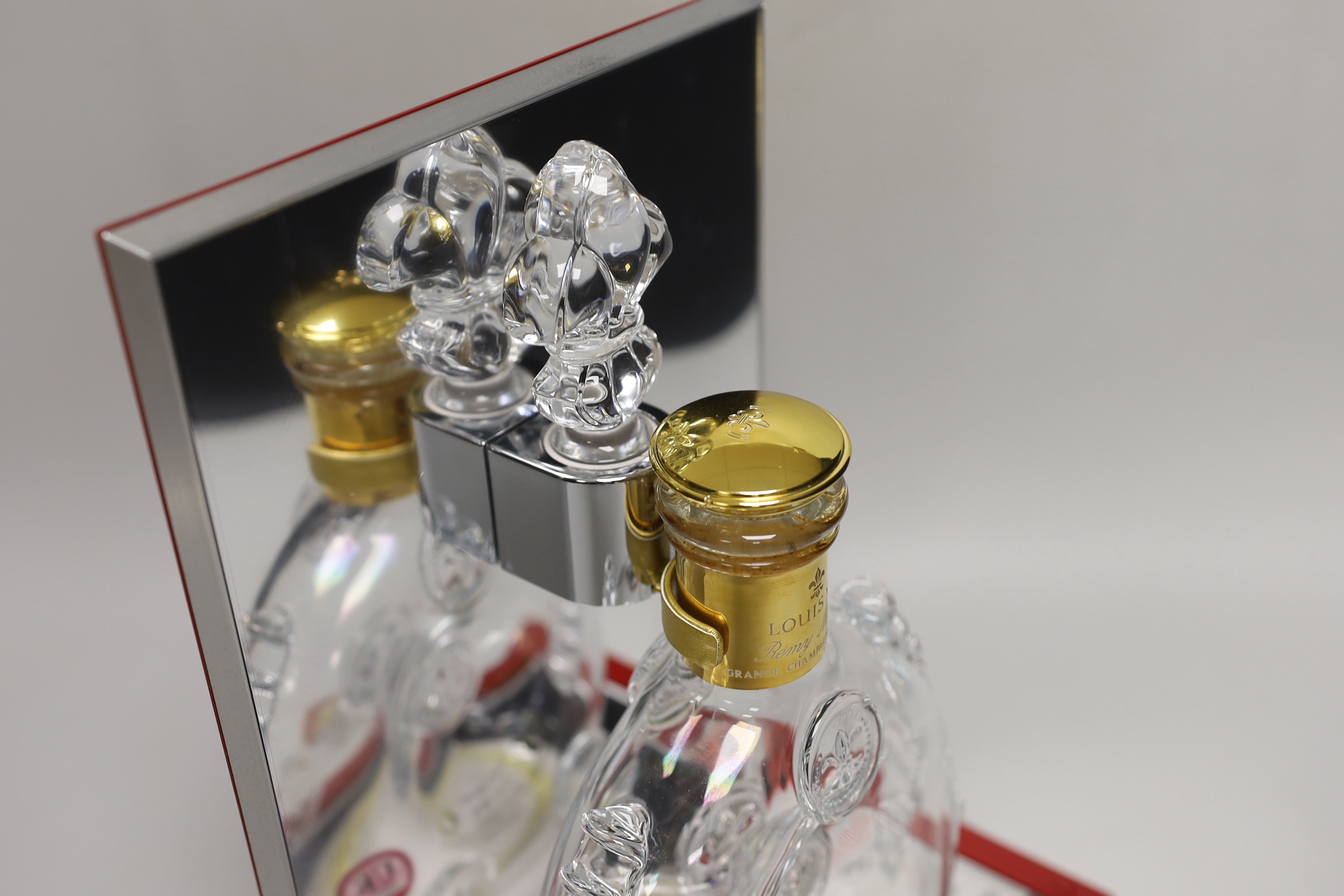 An empty Baccarat Remy Martin Louis XIII decanter, in display case with booklet